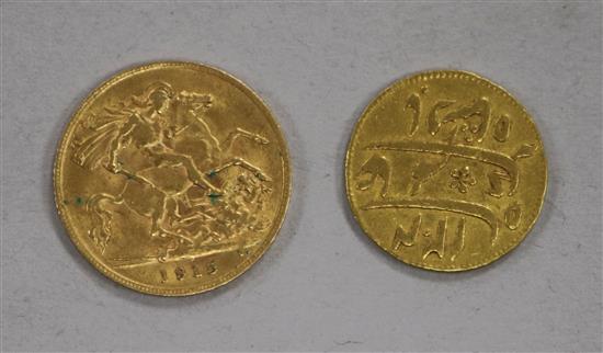 A 1915 gold half sovereign and a Middle Eastern gold coin.